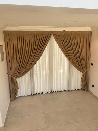 Curtains hung over a voile by KD Dream Space Designs