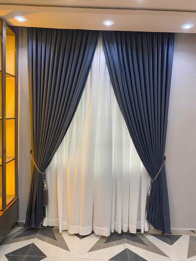 Curtains hung over a voile by KD Dream Space Designs