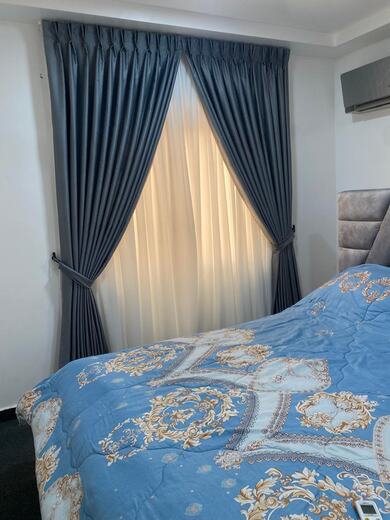 Curtains hung over a voile by KD Dream Space Designs