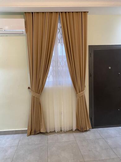 Curtains hung over a voile by KD Dream Space Designs