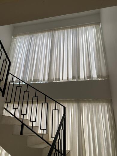 Curtains hung over a voile by KD Dream Space Designs