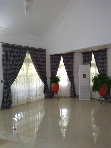 Curtains hung over a voile by KD Dream Space Designs