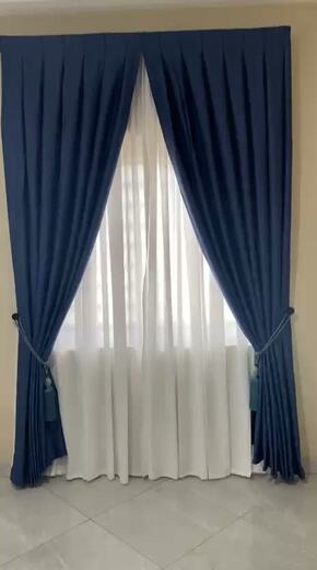 Curtains hung over a voile by KD Dream Space Designs